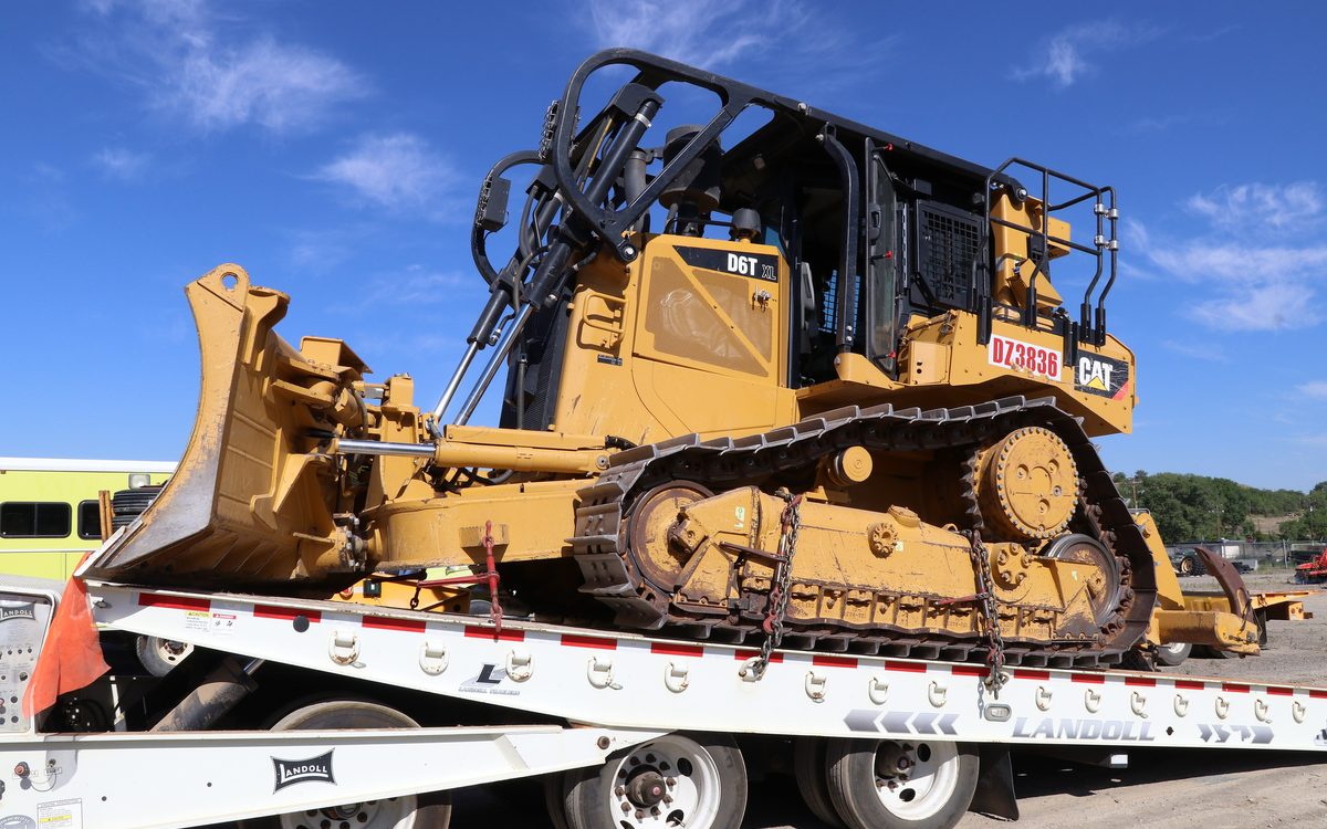 Bulldozer chained down on a lowboy trailer